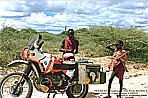 KENYA_native Massais in Amboseli National Park meet BMW motorcycle_2 different worlds_they were staring one hour alternately to the bike, to me and the other way round, they couldn�t really believe it, that somebody crossed their wild National-Park with such a huge motor-cycle_ motorcycle-trip through Eastern-, Central- and Southern AFRICA (Nairobi-Capetown) 1990-91_Jochen A. H�bener